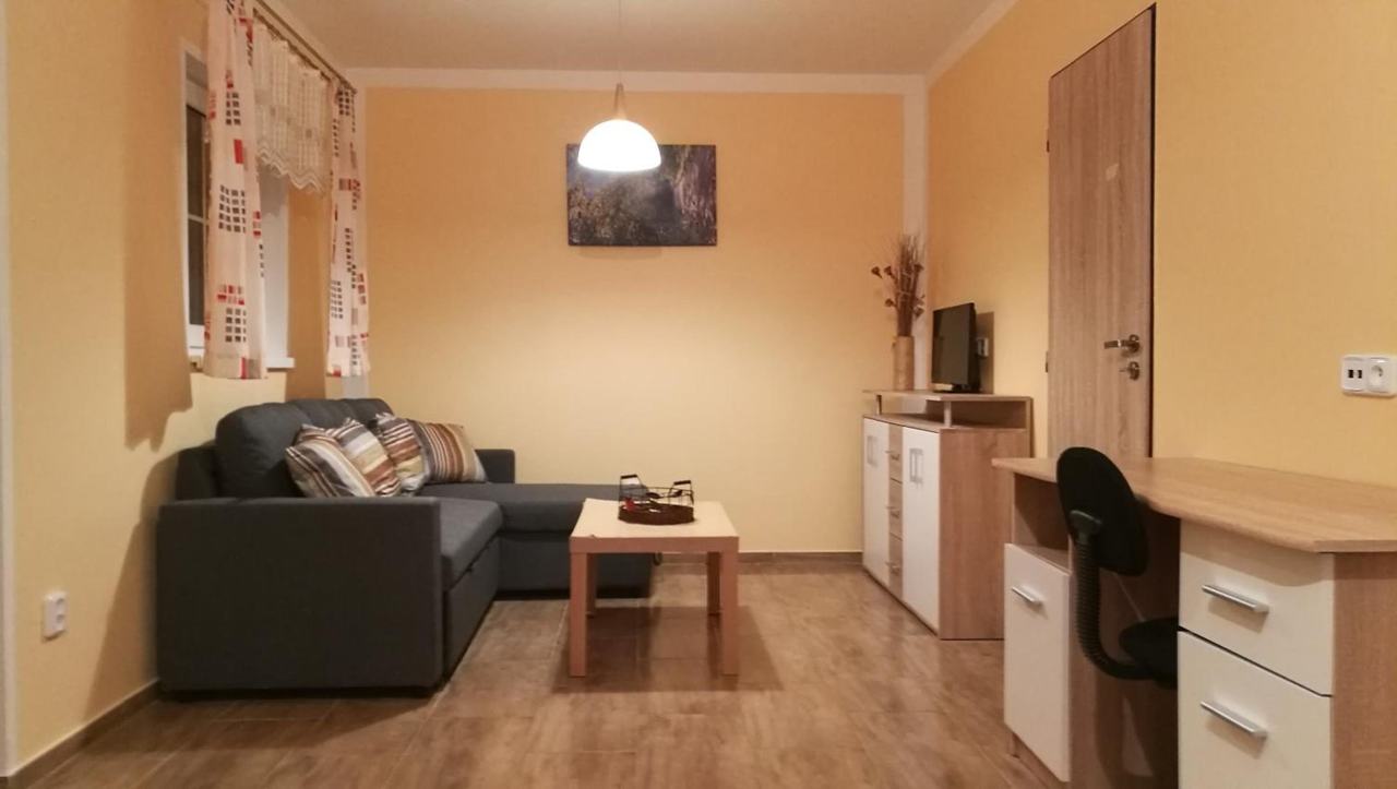 Obývák chaty LUX s šedou rozkládací pohovkou